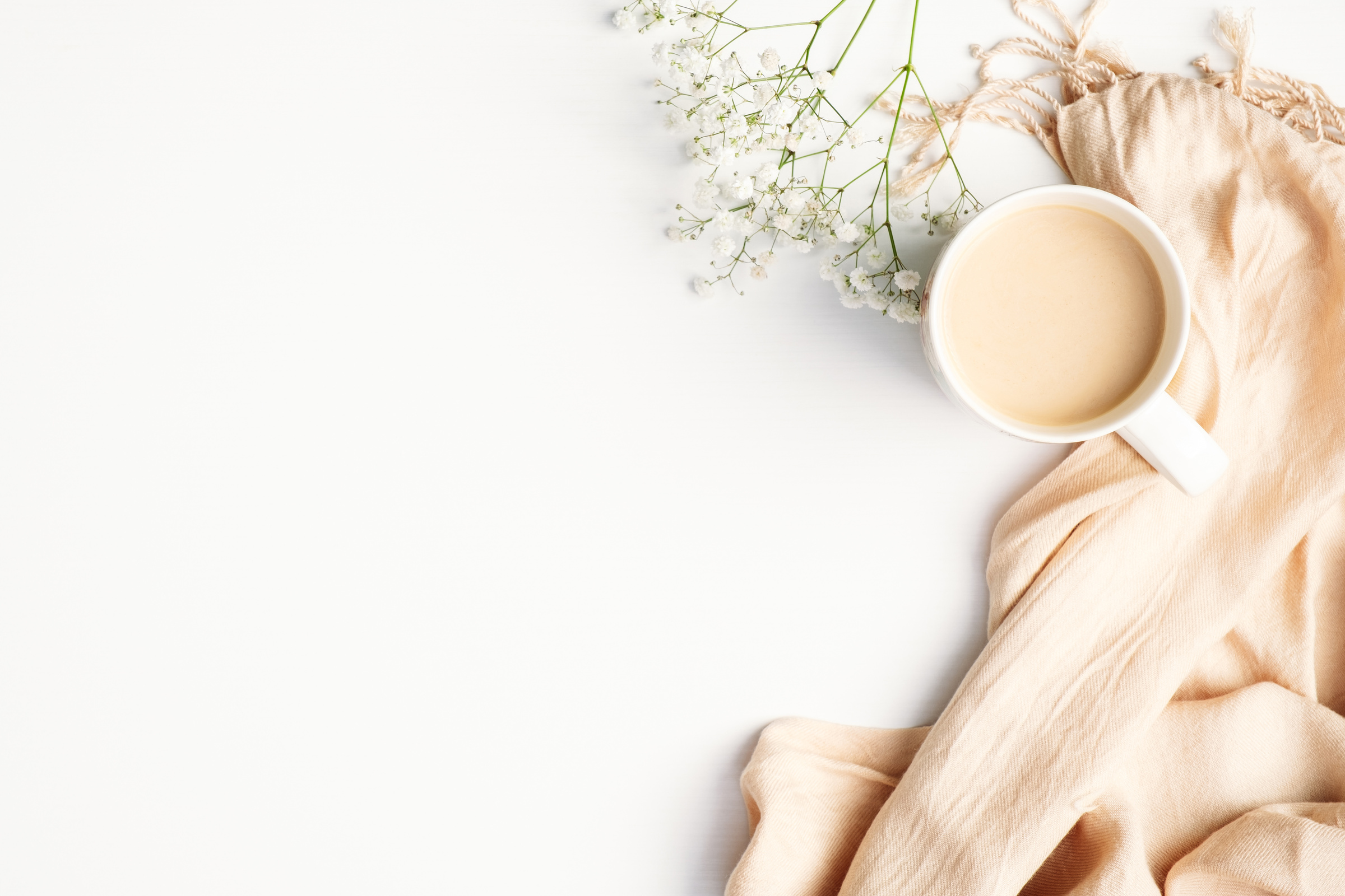 Flatlay of Coffee and Scarf on White Desk